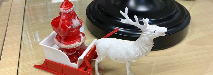 plastic santa in sled pulled by one reindeer