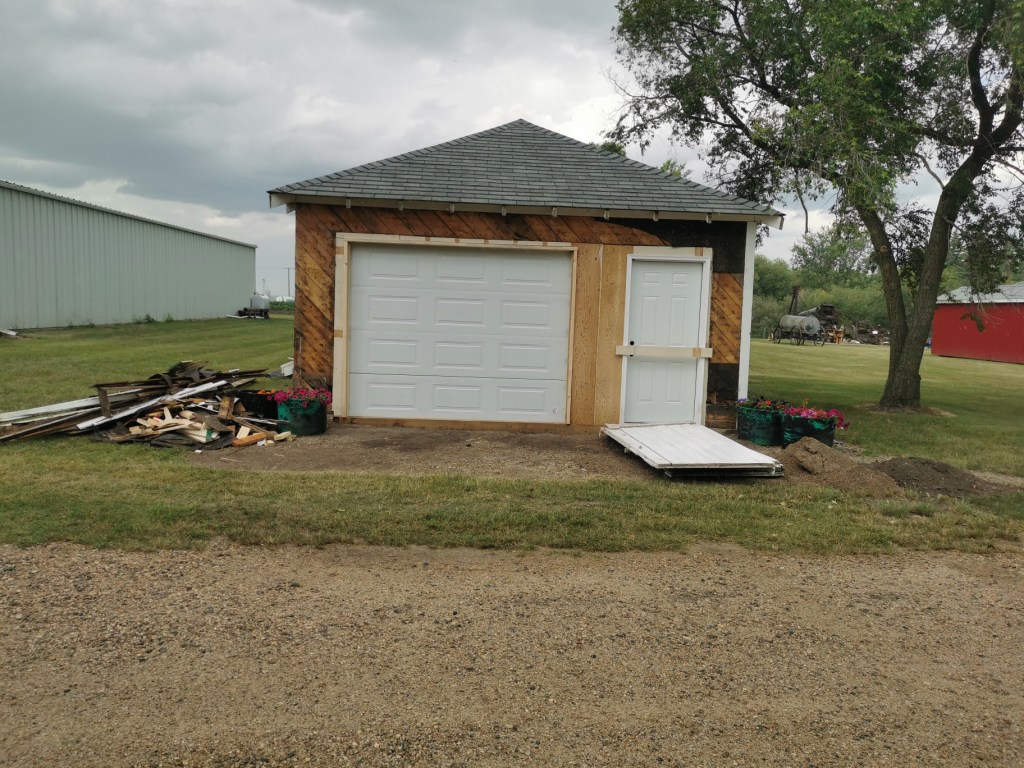 Front view of firehall with overhead and entrance doors installed.