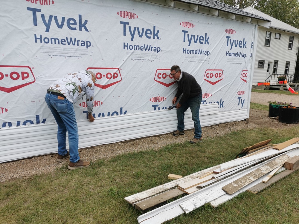 Volunteers installing the new siding